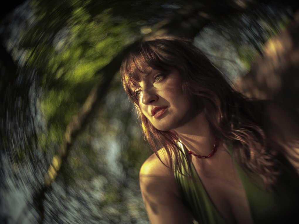 A woman in a fuzzy dream landscape.