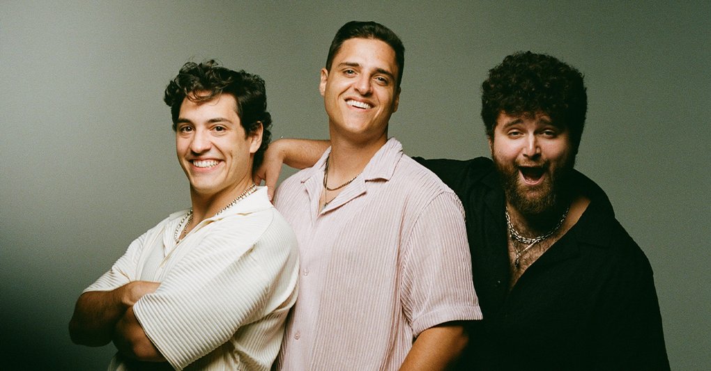 The three members of OCT smiling at the camera