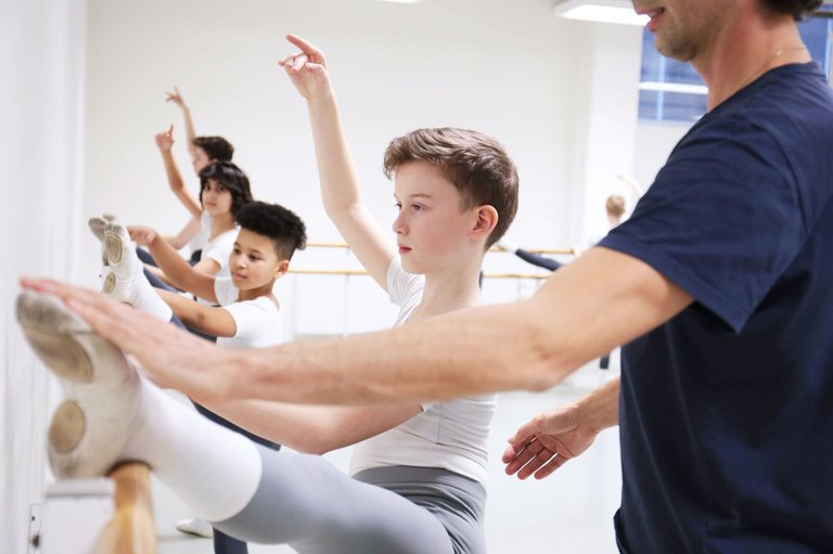 Ballet teacher guiding students at the barre during class at the Royal Swedish Ballet School.