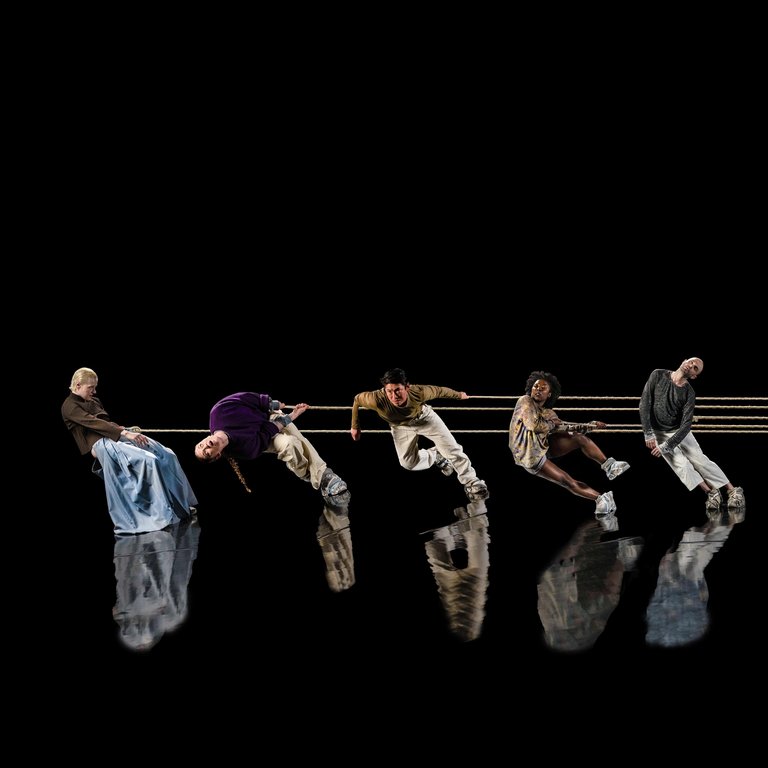 Dancers performing REMACHINE on a stage.