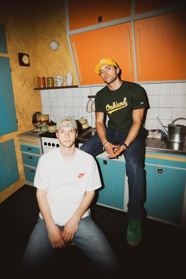 Two Norwegian men in a 1950's kitchen.