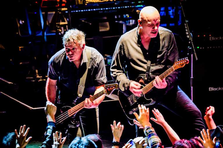 The Stranglers playing on a stage.