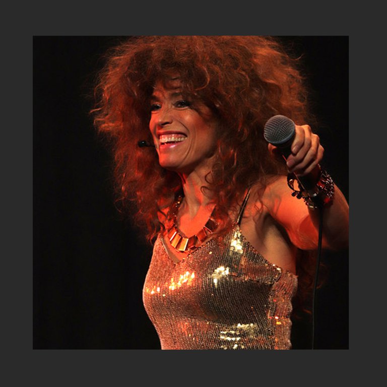 Tina Turner with a microphone.
