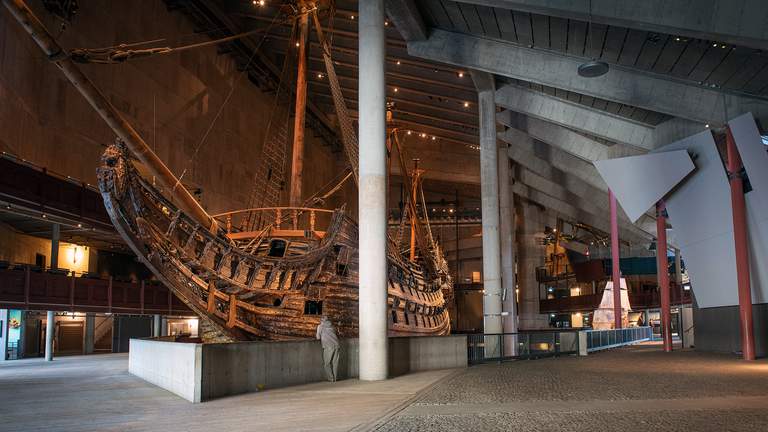 Museums in Stockholm.  A man is standing in front of the battleship Vasa in Stockholm.