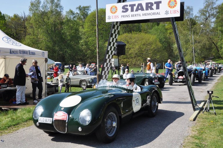 Two people in a vintage car on a vintage car show.