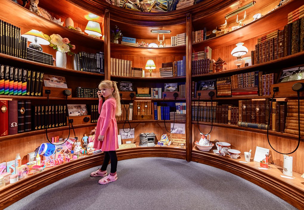 A child at an exhibition hall in a museum.