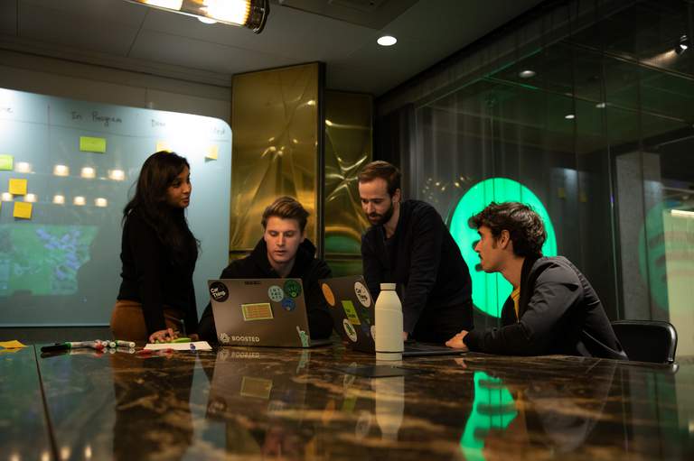 Four people working together inside an office in Stockholm